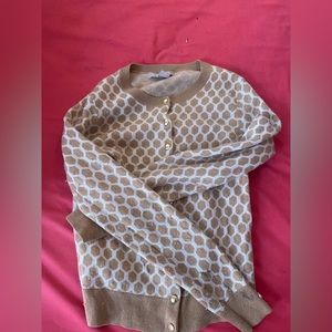 A cardigan with a light brown/beige honeycomb pattering all around.